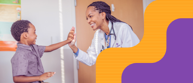 Doctor giving child high five