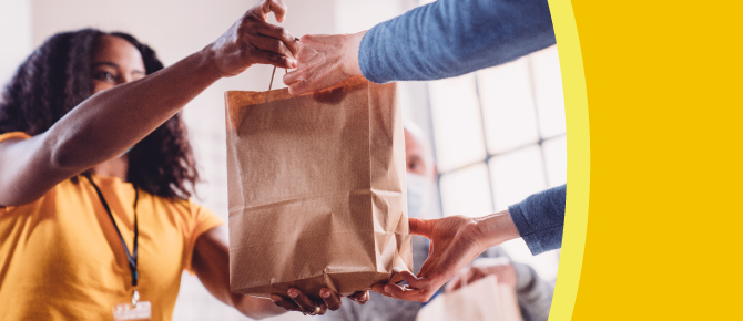 Person receiving bag of groceries