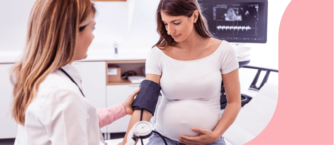 A pregnant woman's healthcare provider checks her blood pressure.