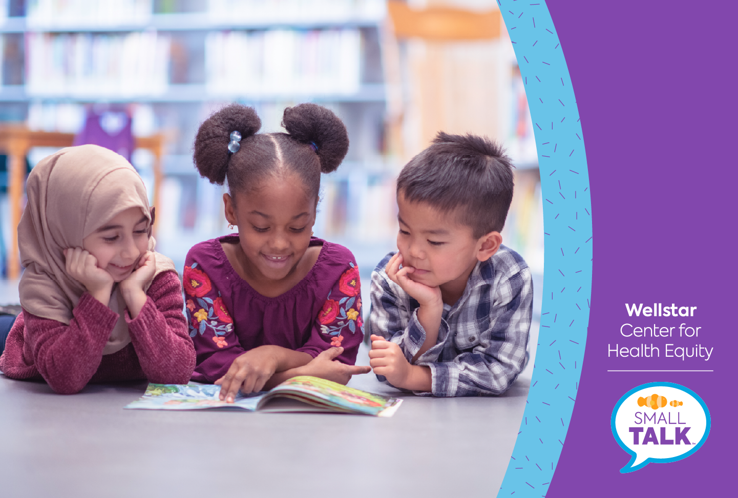 Three young children read a book together