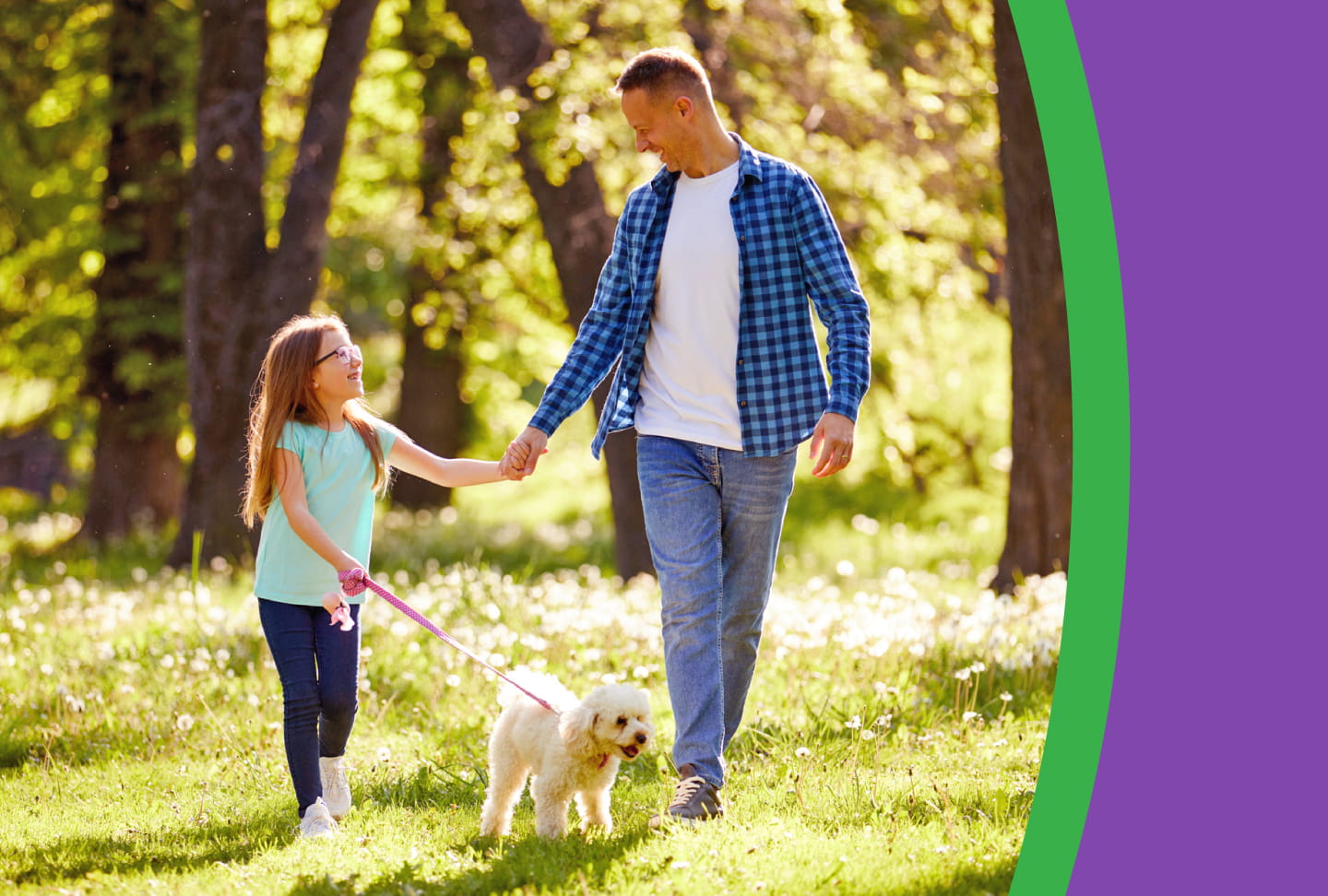 A father and daughter walk with their dog on a bright spring day.