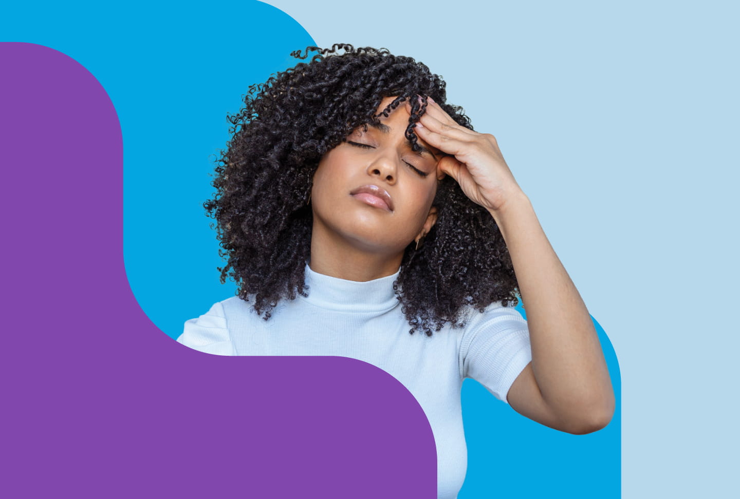 Woman with headache holds her hand to her forehead