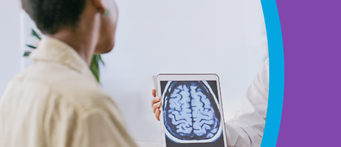 A healthcare provider shows a brain scan to their patient