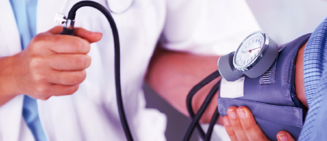 Physician taking a patient's blood pressure