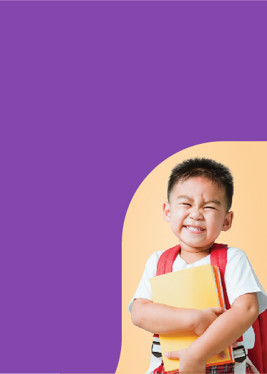 Asian boy smiling holding books and wearing a book bag